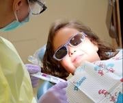 photo of child with dental student 